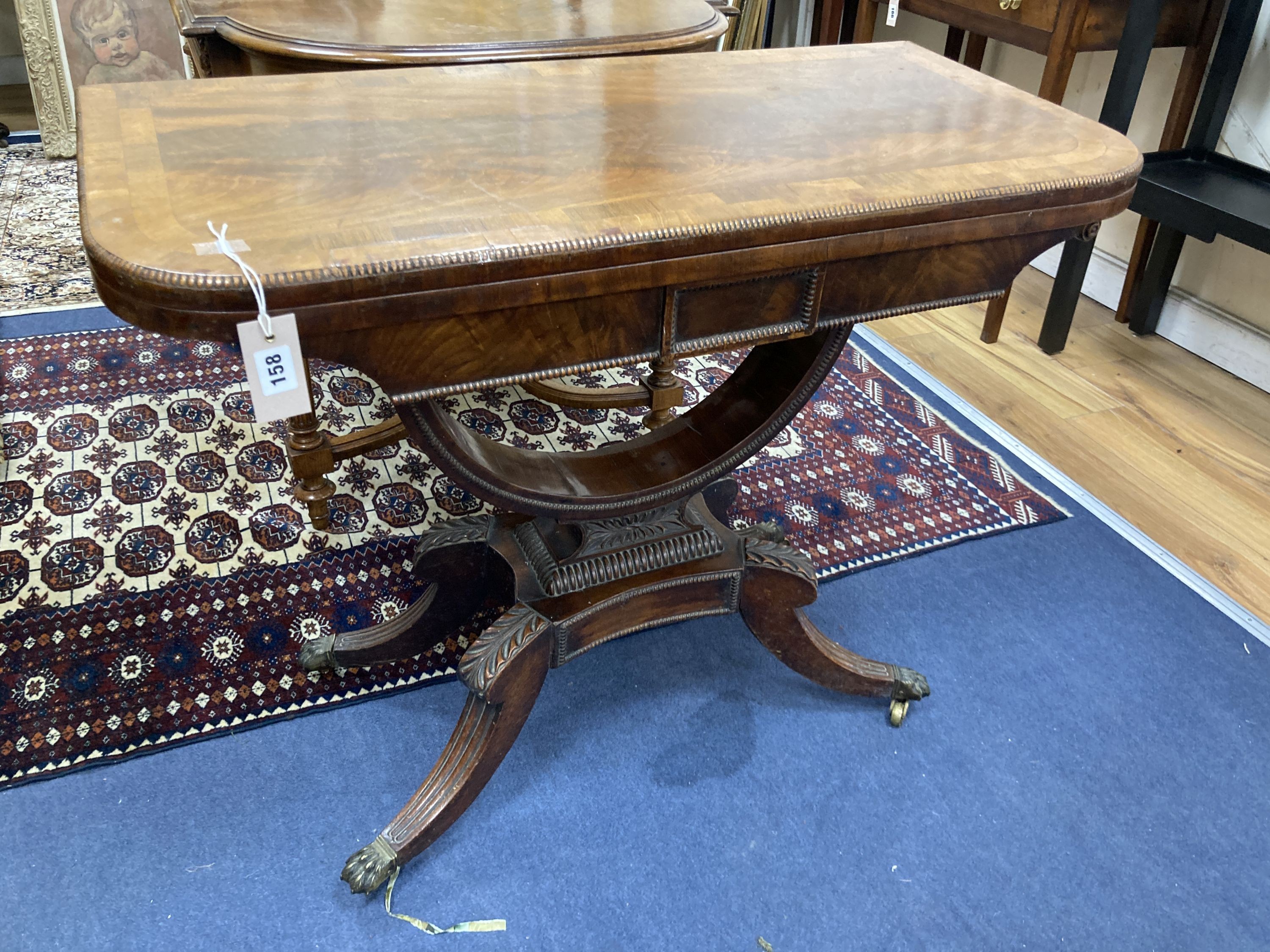 A regency rosewood banded mahogany folding card table. W-90, D-45, H-71cm.
